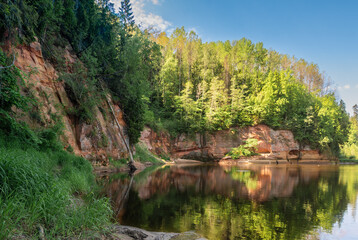 Obraz premium Sandy rock wall on the banks of the River Gauja. Gauja national park, Latvia.(Springu cliffs)