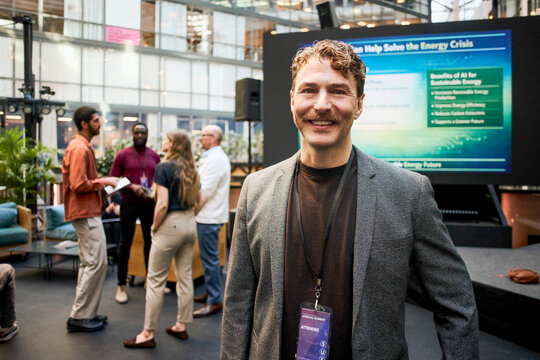 Portrait of smiling male business professional with mustache attending seminar at convention center