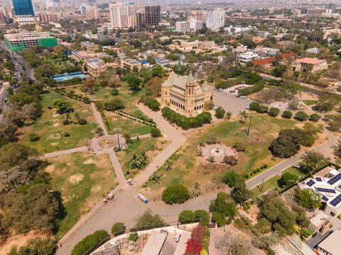Aerial view of the historic Frere Hall building surrounded by lush green parks and the city skyline in Karachi, Sindh, Pakistan.
