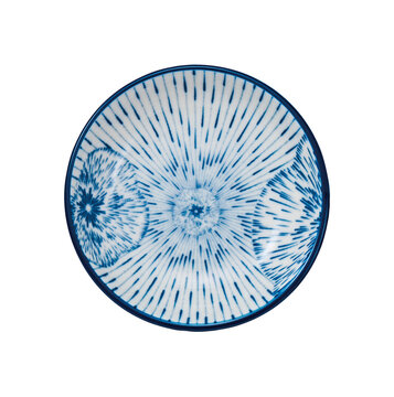 Blue and white ceramic plate with radial line and floral burst pattern isolated on white background
