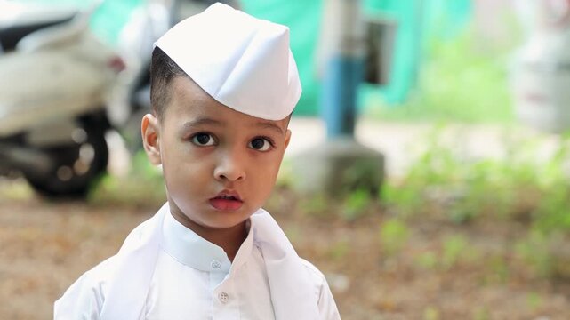 adorable young boy wearing traditional white Gandhi cap in ethnic marathi traditional attire