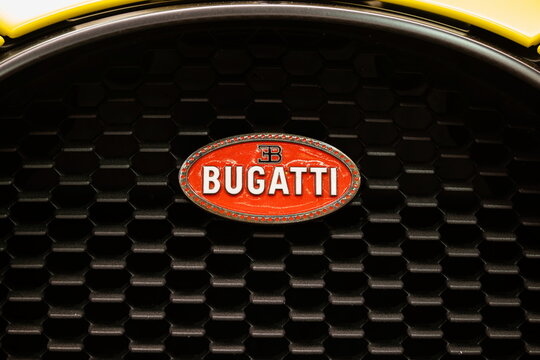 Lucerne, Switzerland, May 30, 2026. Classic red enamel Bugatti oval macaron logo badge on a black grille