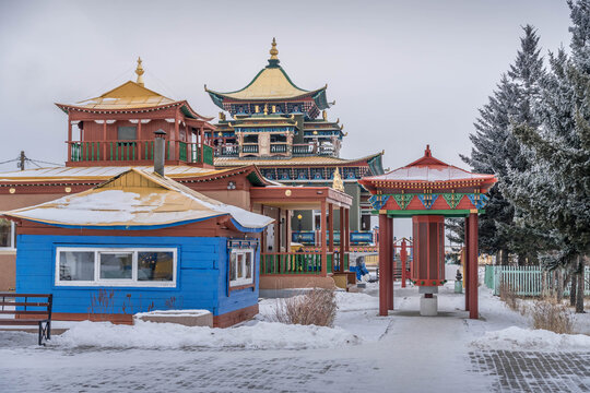 volginsky Datsan Buddhist temple in Buryatia with colorful pagodas in winter snow.
