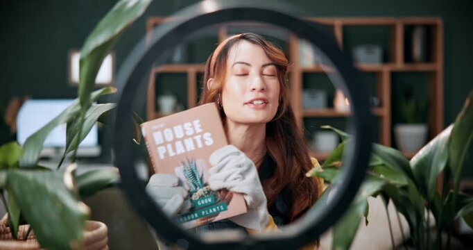 Woman, face and vlogger with plant book in home for online tutorial, gardening advice or tips. Portrait, female person or botanist with story, novel or ring light for agro business help or guide