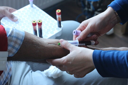 Nurse Taking Blood Sample from Patient