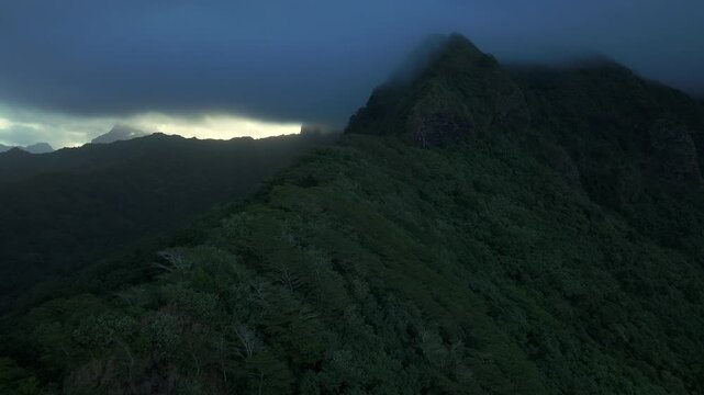 Moorea Tahiti island French Polynesia Belvedere Lookout Mount Toheia Mt Rotui aerial drone sunset low dark cloud layer lush green jungle forest volcanic jagged rugged mountain peaks forward upwards