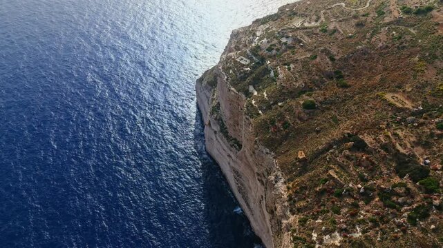 The Dingli Cliffs form a massive natural wall along Malta's isolated western coast, representing the highest point of the Maltese islands at over 250 meters above sea level.