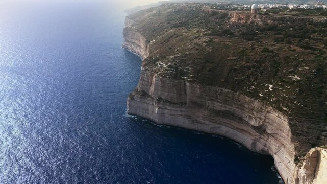 The Dingli Cliffs form a massive natural wall along Malta's isolated western coast, representing the highest point of the Maltese islands at over 250 meters above sea level.