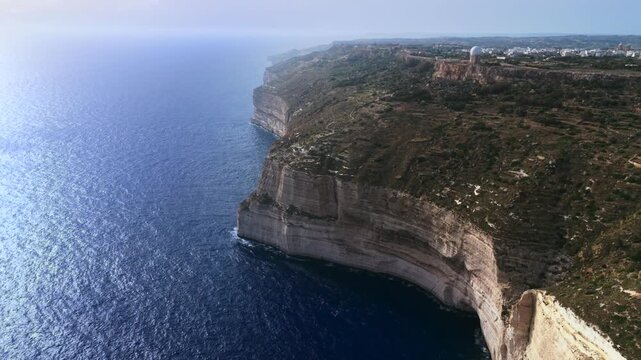 The Dingli Cliffs form a massive natural wall along Malta's isolated western coast, representing the highest point of the Maltese islands at over 250 meters above sea level.
