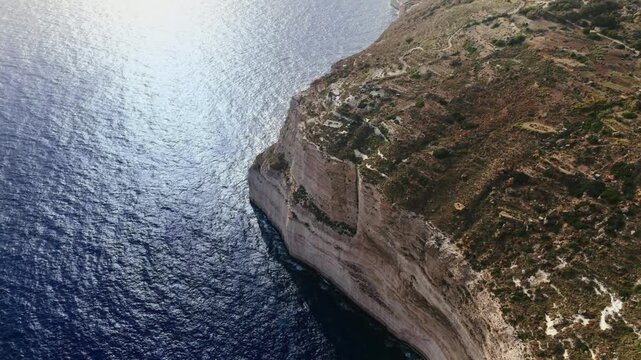 The Dingli Cliffs form a massive natural wall along Malta's isolated western coast, representing the highest point of the Maltese islands at over 250 meters above sea level.