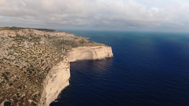 The Dingli Cliffs form a massive natural wall along Malta's isolated western coast, representing the highest point of the Maltese islands at over 250 meters above sea level.