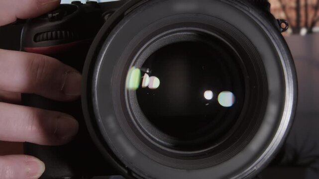 Lens aperture opens and closes when photographer takes photo by pressing camera's shutter button close-up