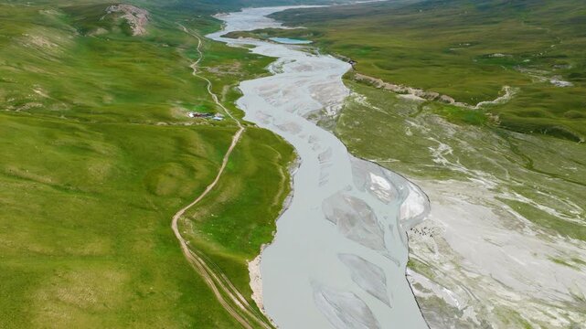 Above Sary Jaz River Flowing Through Valley Within The Tien Shan Mountains In Kyrgyzstan, Central Asia. Aerial Drone Shot