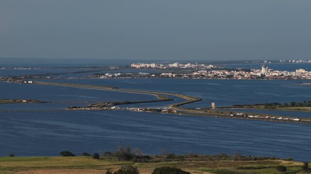 Lagoon landscape with dikes and distant Palavas-les-Flots skyline, southern France