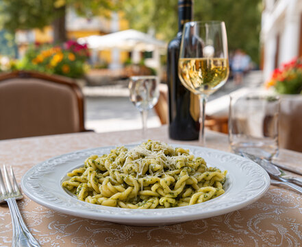 Traditional Trofie al Pesto Served at Italian Restaurant Terrace with White Wine