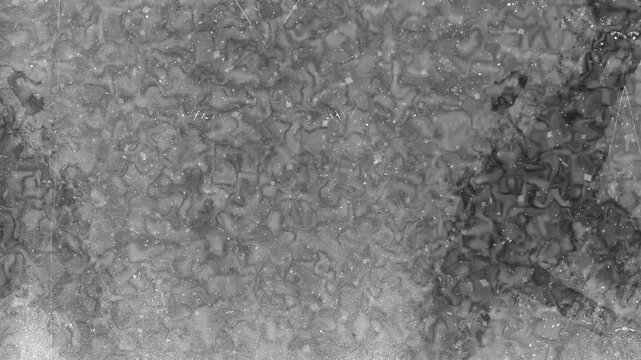 Microscopic silver halide crystals on film grain in dark and light grey textures. Suitable for abstract backgrounds and artistic projects.