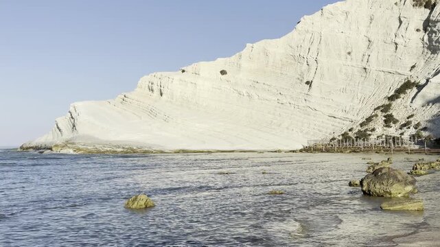 sea waves breaking along the white limestone coast of Scala dei Turchi in the morning, Sicily, Italy.