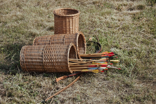 Wicker quiver or arrow basket with a bow on the ground