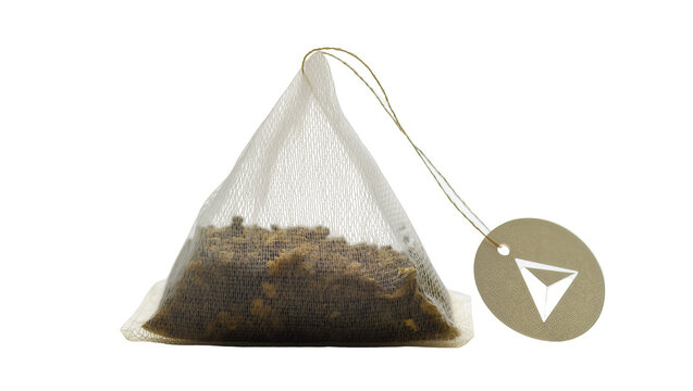 Triangular mesh tea bag filled with loose leaf tea, isolated on transparent background
