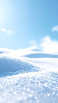 Soft focus winter landscape with gentle snowdrifts under a pale blue sky.