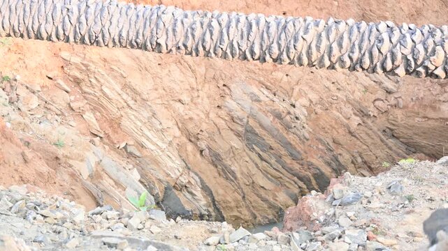 A well that has caved in during the rains.
It is filled with muddy water. This situation has arisen because this well could not be completed during the summer season. 
