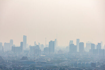 Fototapeta premium Dense modern city metropolis obscured by heavy fog and thick dangerous air pollution.