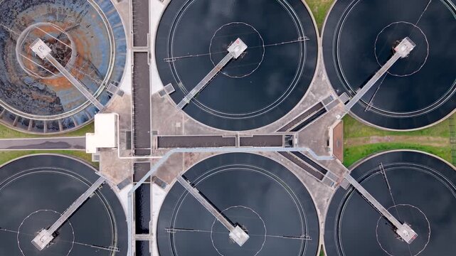 Aerial birds eye view of circular basins at a wastewater treatment facility. Rising Shot