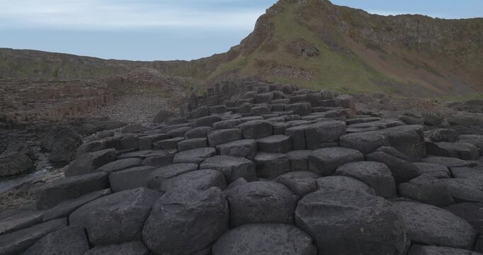 revealing shot of hexagonal basalt rock formations at the Giants Causeway
