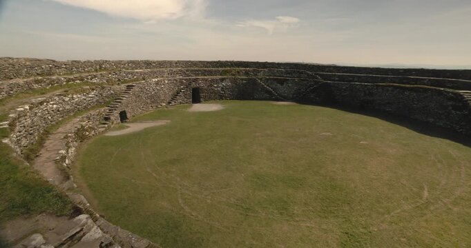 revealing shot of the stone walls with staircases within the Grianan of Aileach