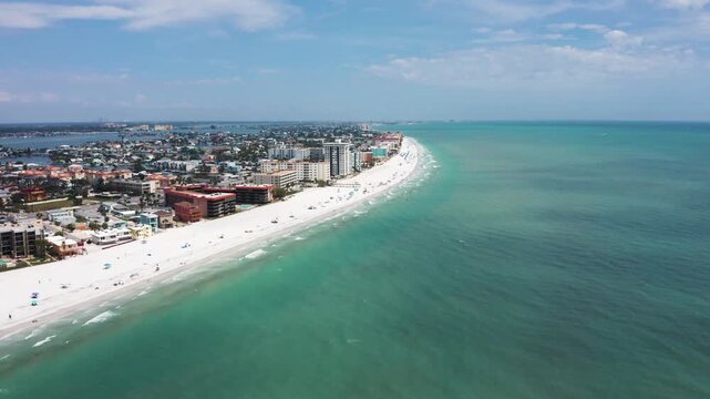 Aerial view showcasing Indian Shores Beach's long stretch of white sand and adjacent urban skyline. Ideal for tourism content or coastal development features.