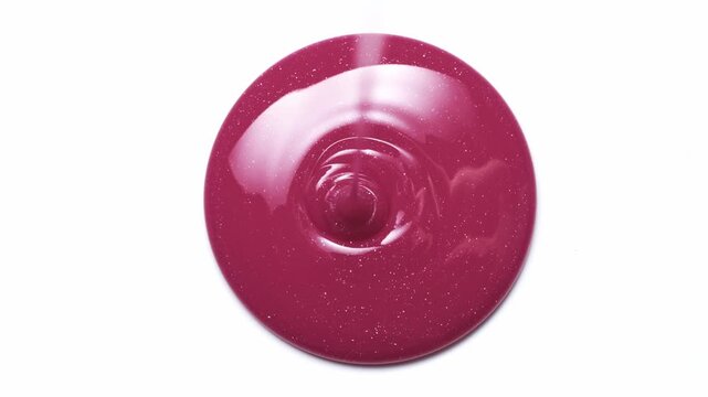 Pink lip gloss dripping down on white background. Lipgloss cosmetic texture drops. Satisfying make up swatch
