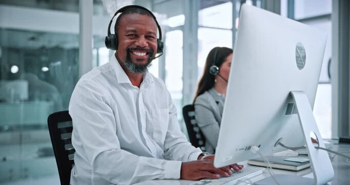 Face, consultant and businessman with headset in office, laugh and confident for career development. Call center, coworking and mature person with computer for lead generation, happy and typing info