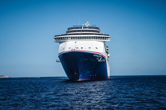 Front bow view of the Carnival Spirit cruise ship anchored in the deep blue sea near the coast of Baja California Sur during a vacation voyage.