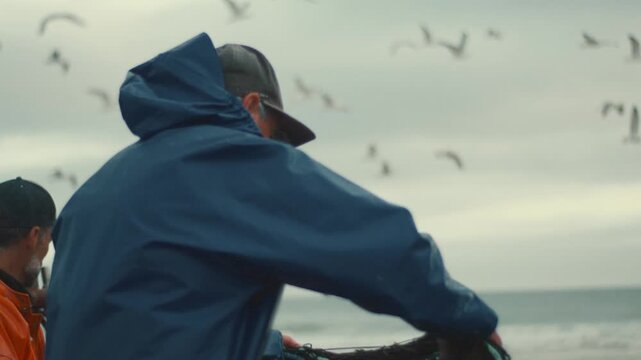 Fisherman pulling a fishing net from the sea