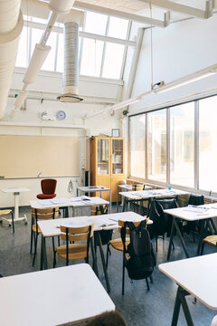 Desks and chairs in classroom at junior high school