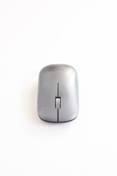 Vertical composition of a modern wireless computer mouse centred on a clean white background with ample negative space for design use.
