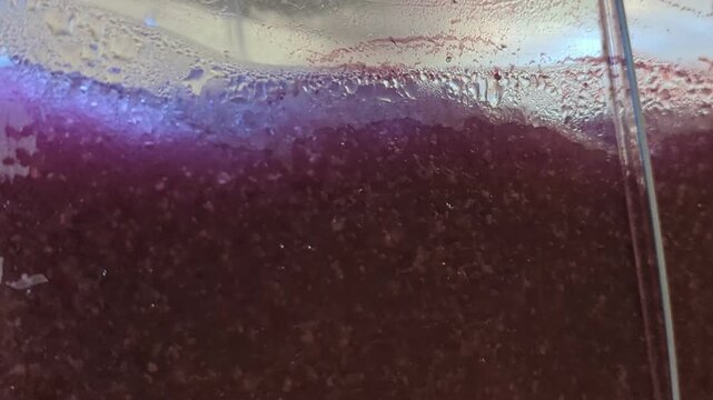 Close-up of refreshing blueberry slushie texture blending in a frozen beverage machine