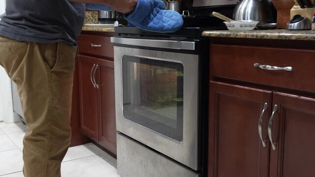 Bread Being Placed into the Oven at Home