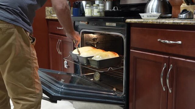 Freshly Baked Bread Being Brushed with Butter