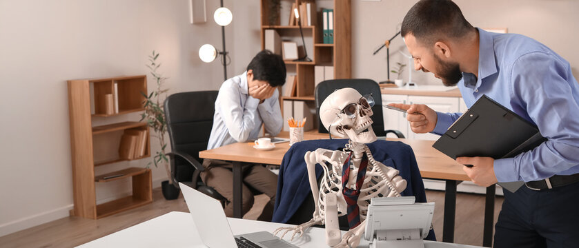 Angry businessman shouting at human skeleton in office