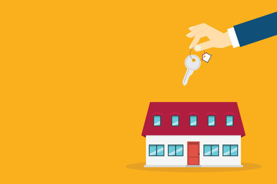 Hand holding key over the house. House buying