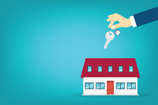 Hand holding key over the house. House buying