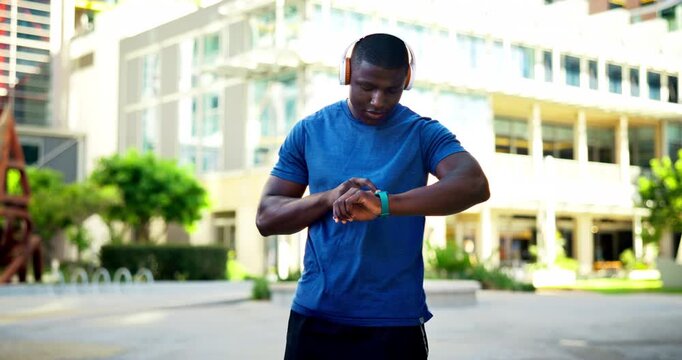 City, headphones or black man with smart watch for fitness, getting ready or select training playlist. Town, motivational podcast or runner with tech to start streaming, jog tracker or exercise music