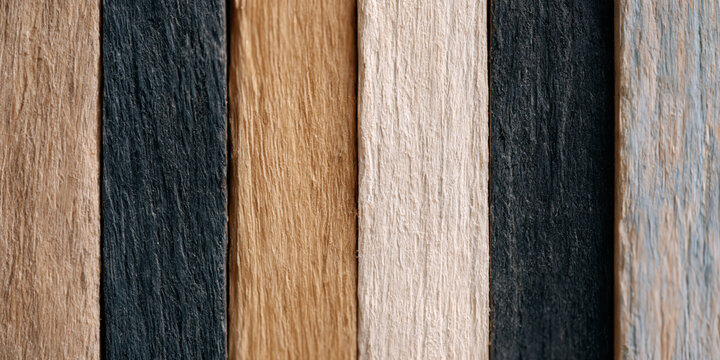 brown wooden acoustic panel texture shows rustic vertical timber slat arrangement creating moody geometric shadow play