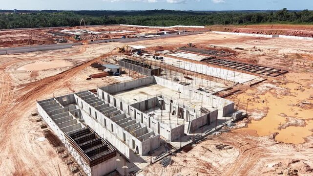 aerial construction, drone view, building site, top perspective, crane shadow, excavation pit, dirt track, steel framework, cement mixer, material stockpile, tiny worker, parked truck, foundation hole