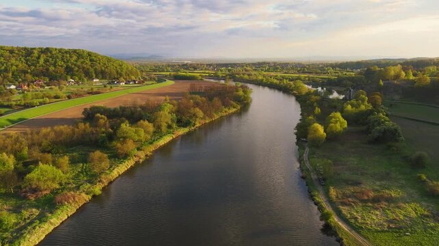 An aerial flyover of the Vistula River in Poland at sunset in spring.