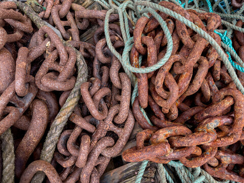 Jumble of ropes and rusty chains in a fishing village - Cornwall - United Kingdom