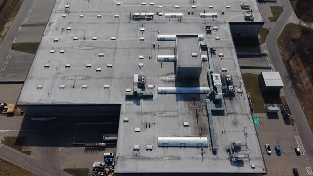 Drone Aerial Warehouse Rooftop Showing Hvac Vents, Maintenance Technicians Conducting Inspection, Gray Concrete Expanse, Rooftop Units, Access Hatch, Service Vehicles In Yard, Supply Chain