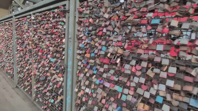 Love locks cover the railway bridge in Cologne, creating a colorful display of promises and memories
