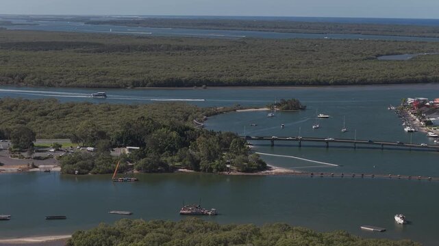 Boats On Coombabah Creek Near Jabiru Island With Road Bridge. Paradise Point, QLD, Australia. aerial shot